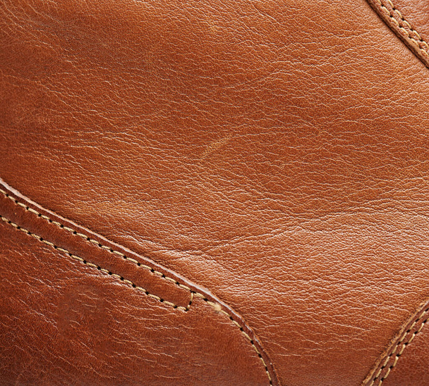 Oberfläche aus braunem Leder mit Liniennähten Nahsicht - Foto, Bild
