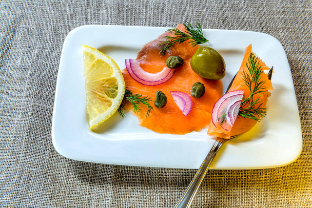 salmon with lemon and rosemary on a plate - Photo, image