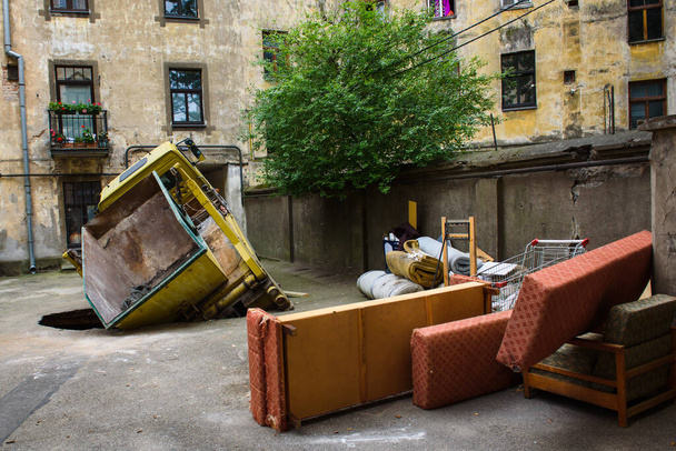 RIGA, LATVIA. 21st September 2020. Mercedes Benz Ateco truck with building refuse container crashed into broken asphalt at courtyard. - 写真・画像