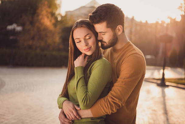 Passionate couple guy embrace cuddle his girlfriend in fall october nature town park wear yellow green turtleneck sweater - Fotografie, Obrázek