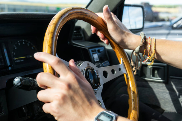 man's hands hold the steering wheel of a car.  young man driving - Foto, Imagen