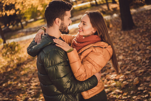 Photo of passionate affectionate couple girl hug soulmate boyfriend in fall forest september park wear jackets coats - Fotoğraf, Görsel