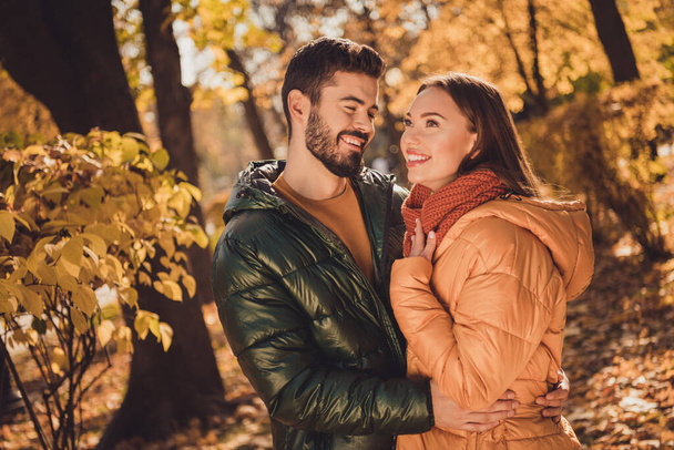 Photo of affectionate romantic couple guy hug his girlfriend in autumn september outside forest park - Fotoğraf, Görsel