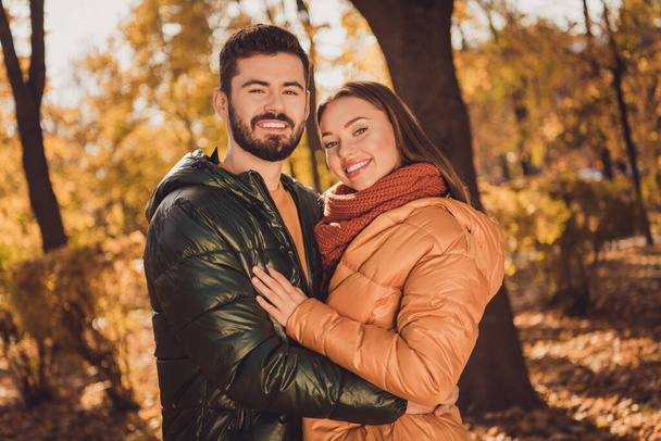 Photo of affectionate bonding couple guy hug his girlfriend in autumn outside town park - Фото, зображення