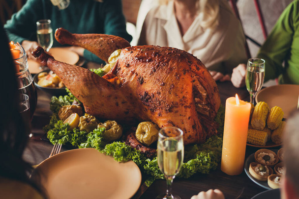 Cropped photo served table thanks giving dinner garnished turkey family generation gathering evening blessing candle fire living room indoors - Foto, Bild