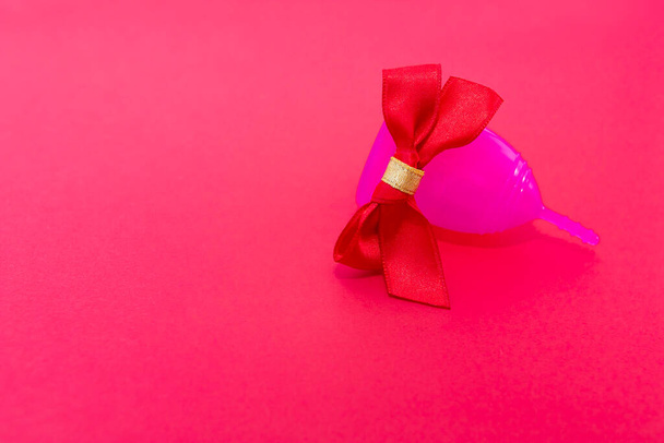Menstrual cup as a gift, flat lay on pink background. Zero waste concept. Caring for the environment. Women Health. Picture with place for text - Fotó, kép