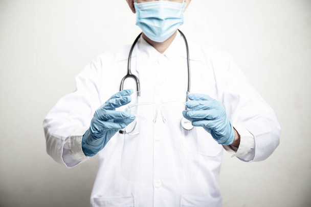 Doctor Man on blur hospital laboratory panoramic blue background. COVID-19 virus epidemic outbreak to Coronavirus pandemic disease global recession wide concept for social scientist vaccine - Photo, image