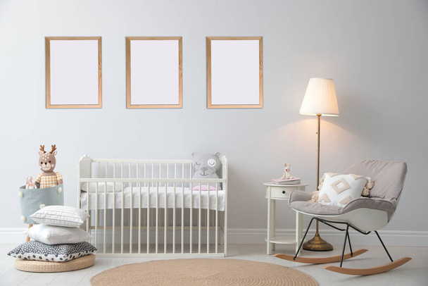 Stylish nursery interior with empty posters on wall. Mockup for design - Photo, image