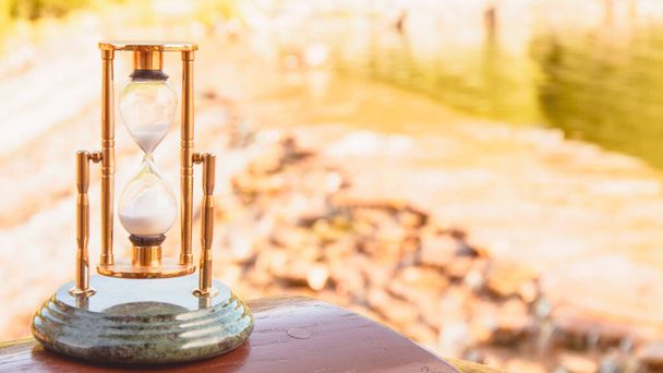 Krásné zlaté přesýpací hodiny na pozadí přírody - Fotografie, Obrázek