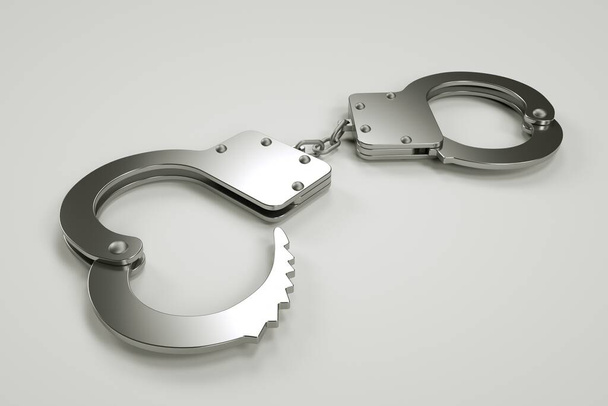Metal handcuffs lie on a gray background, arrest and detention, violation of the law - Valokuva, kuva