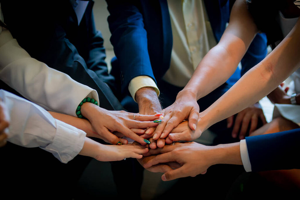 People putting their hands together. Friends with stack of hands showing unity and teamwork. Business people join hand together during their meeting. Team work concept. Business people joining hands. - Foto, Bild