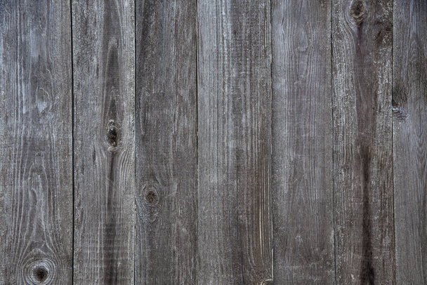 old wooden fence made of boards with peeling paint and scratches, background, grunge - Photo, Image