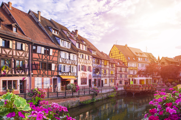 Sunset in Colmar. Famous landmark, romantic village with multicolor half-timbered houses by the bank of canal, unrecognizable people. Summertime, Alsace France. - Photo, Image