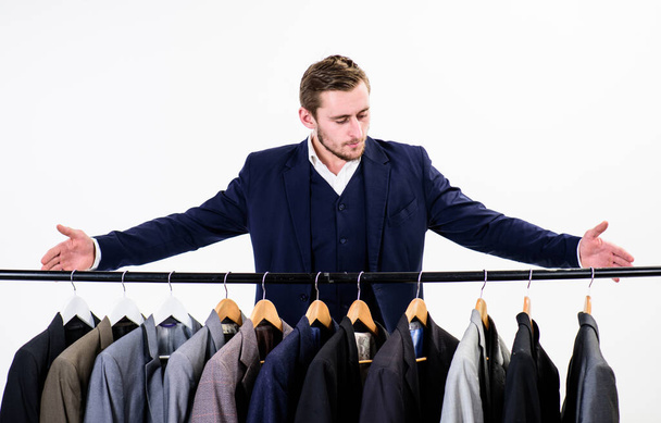 Macho on strict face presenting exclusive handmade clothes, suits - Fotoğraf, Görsel