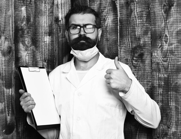 Bearded brutal caucasian doctor or postgraduate student with clipboard - Fotografie, Obrázek
