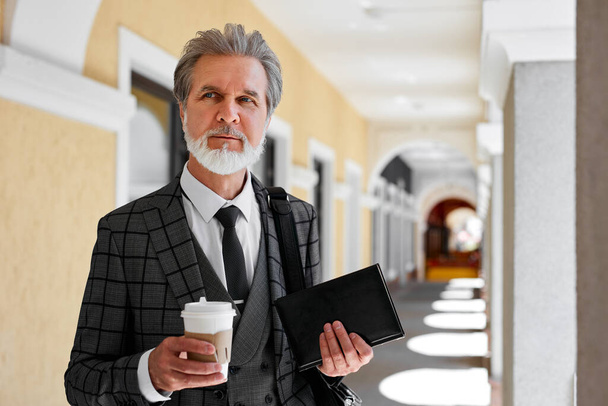 senior businessman make sip of fresh coffee before working day - Photo, image