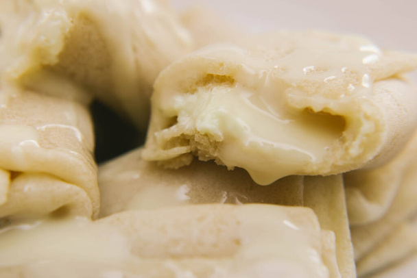 close-up of pancakes stuffed with cottage cheese and poured with condensed milk - Valokuva, kuva
