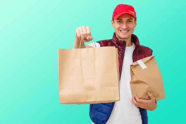 Delivery man in mask and gloves bring fresh food to customer's home. Stay home. Online shopping concept. blue background - Photo, Image
