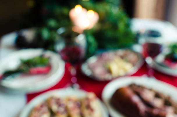 Blurred background of festive table setting for holiday dinner with dishes. Family together Christmas or New Year celebration concept. Copy space. - Photo, image