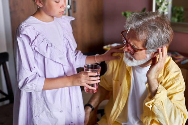 girl asks grandfather to drink medicine - Valokuva, kuva