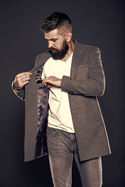 Pocket inside coat. Serious concentrated man. Caucasian man with brutal appearance. Bearded man with moustache and beard on unshaven face in brutal style. Brutal hipster wearing casual outfit - Foto, Imagem