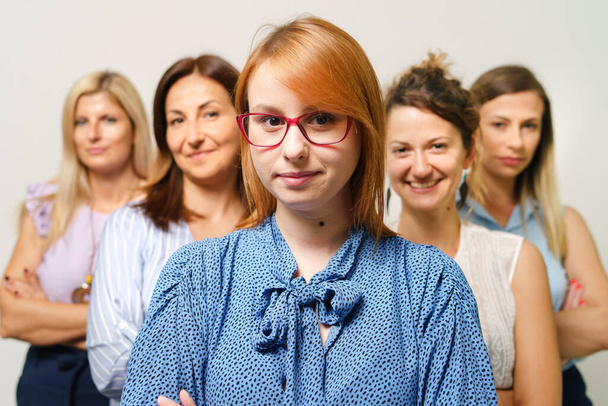 Female boss entrepreneur with women colleagues standing together as team selective focus - Businesswomen females only concept gender equality - Fotó, kép