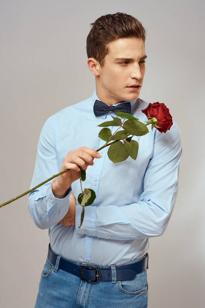 romantic man with red rose and light shirt pants suit - Fotó, kép
