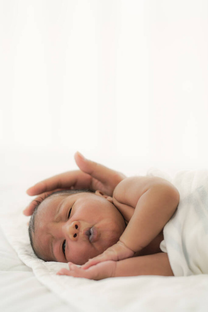 african american new born baby lying on white bed - Φωτογραφία, εικόνα
