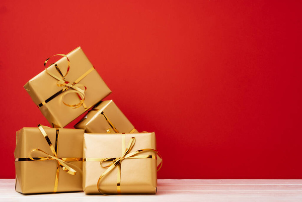 Christmas gift boxes against red background front view - Foto, immagini