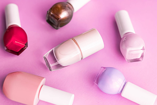 Nail polish bottles on pink background, beauty brand - Foto, Imagen