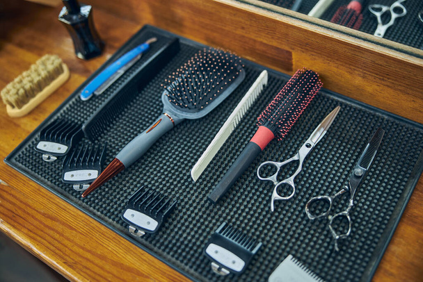 HIgh-quality barbering equipment setup on a table in a barbershop - Fotó, kép