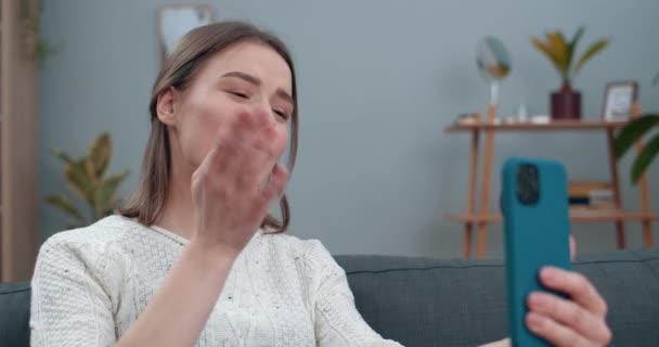 Close up view of deaf woman having video conversation and showing with sign language phrase Go for coffee. Female person smiling and using mobilephone for communication. Hearing loss. - Materiał filmowy, wideo