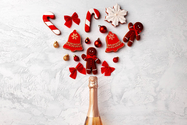 Golden champagne bottle with Christmas gingerbread flatlay - Фото, изображение