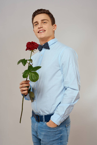 romantic man with red rose and light shirt pants suit - Fotoğraf, Görsel