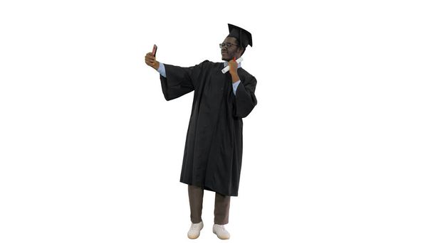 Happy african american male student in graduation robe taking ph - Photo, image