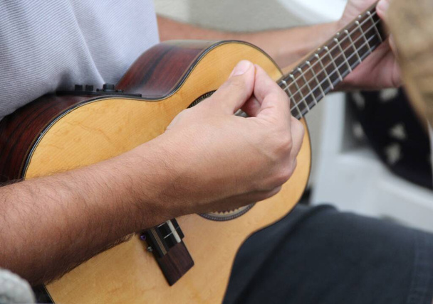 Closeup view of man hand playing on guitar - Photo, Image