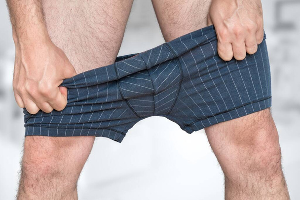 Man puts on or undressing his underpants - Fotoğraf, Görsel
