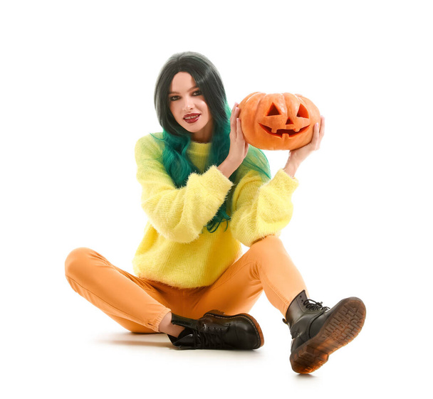 Mooie jonge vrouw met Halloween pompoen op witte achtergrond - Foto, afbeelding