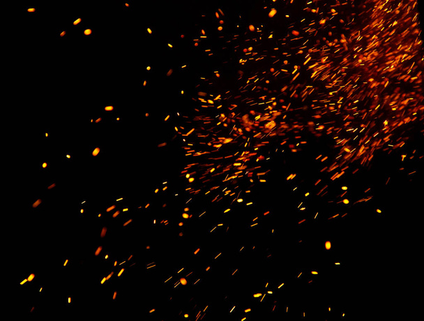 fire flames with sparks on a black background - Foto, afbeelding