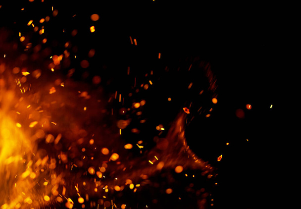 Полум'я вогню з іскрами на чорному тлі
 - Фото, зображення