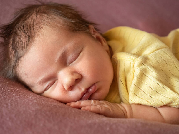 Portrait of 8 days old newborn baby girl sleeping - Fotó, kép