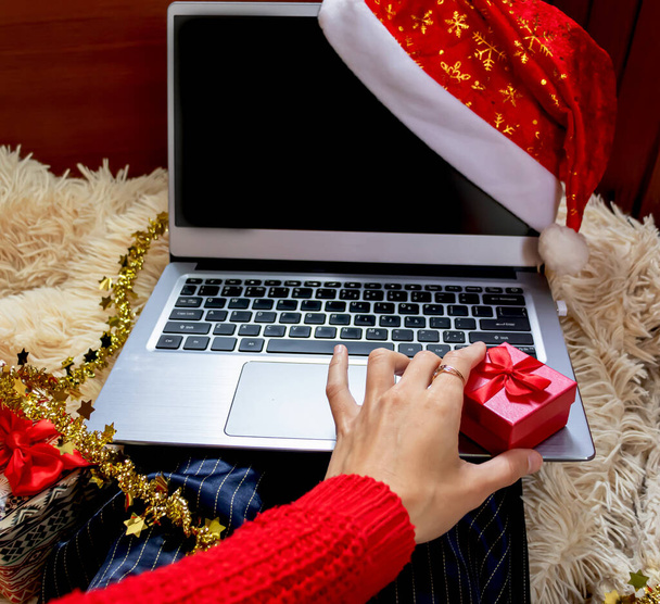 クリスマスオンラインショッピングトップビュー。手に赤い箱。冬休み営業 - 写真・画像