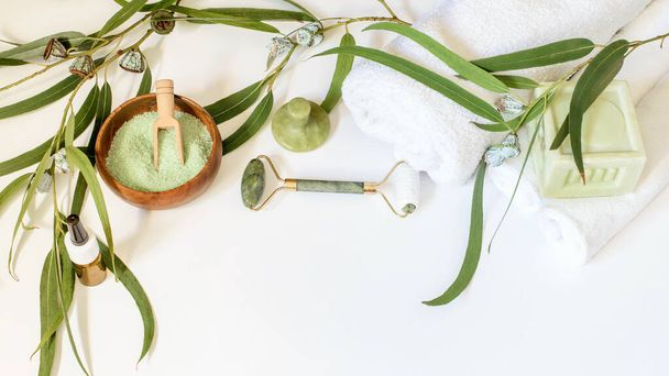 Facial gua sha jade gem therapy, eucalyptus soap, salt and essence oil. Spa relaxation, face and body care, wellness concept.  - Photo, Image