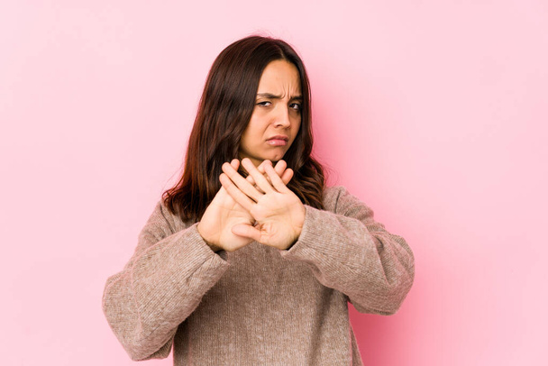 Young mixed race hispanic woman isolated doing a denial gesture - 写真・画像