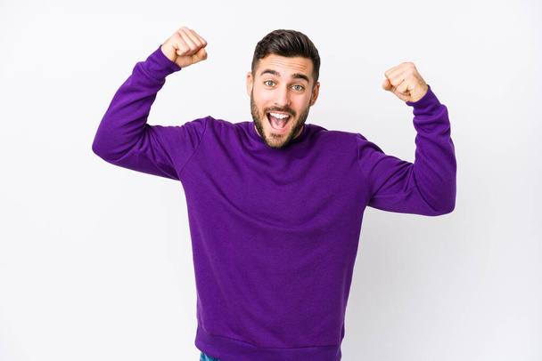 Young caucasian man against a white background isolated showing strength gesture with arms, symbol of feminine power - Photo, Image