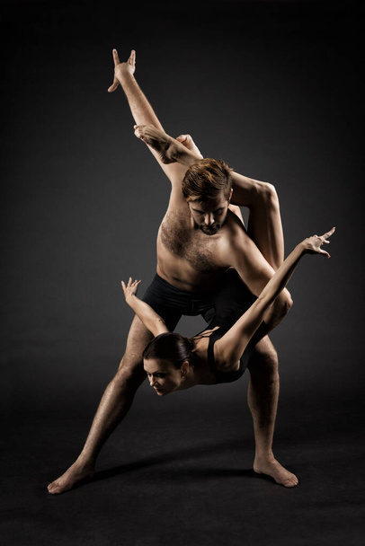 Ballet Dancers. Modern Ballerina Couple Posing over Gray Background - Photo, Image