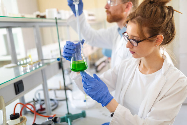 Female student, scientist of chemistry working in laboratory - Фото, изображение