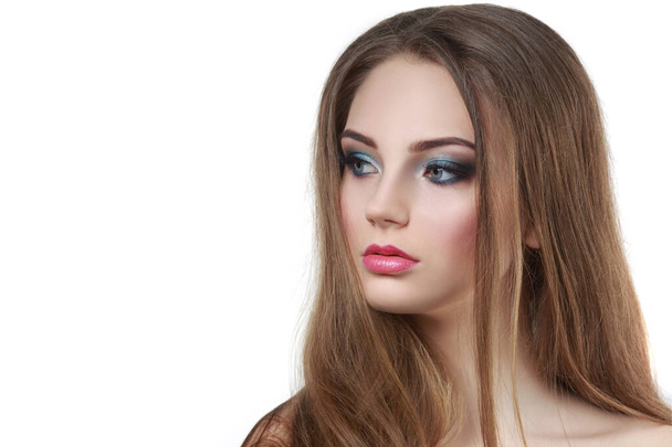 Beauty portrait of a beautiful girl with a bright make-up and long hairmelted over white background. - Foto, Imagen