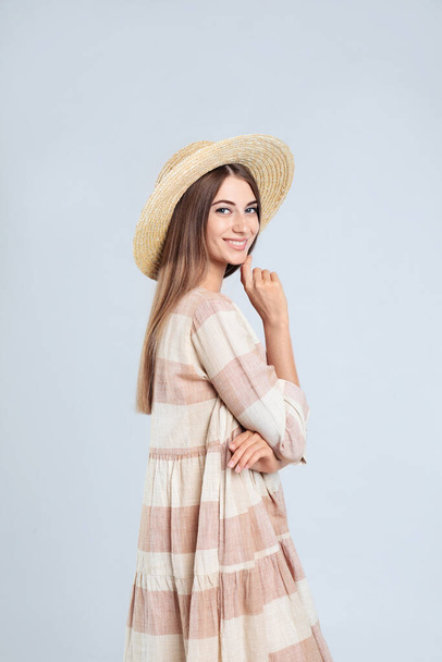 Young woman wearing stylish dress on light grey background - Fotografie, Obrázek