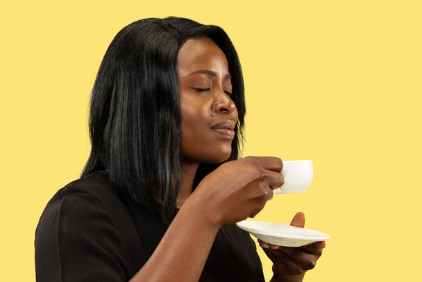 Young african woman isolated on yellow studio background, facial expression - Φωτογραφία, εικόνα